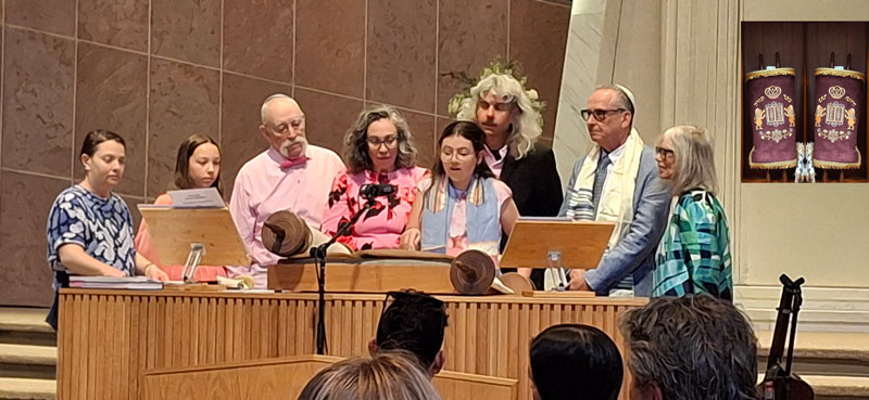 Group gathered at the bimah during a Torah service